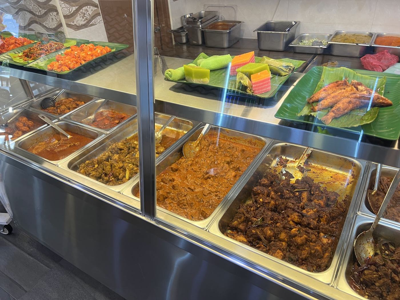 Food counter with trays and kuih